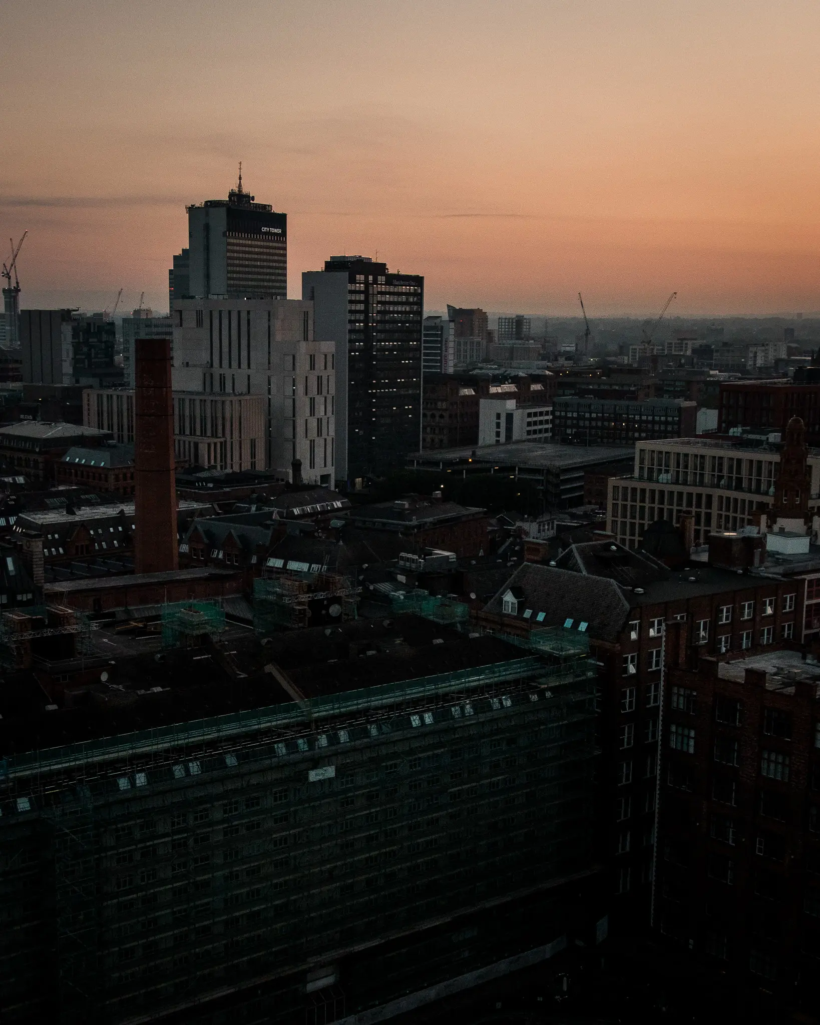 Manchester skyline at sunrise with construction crane